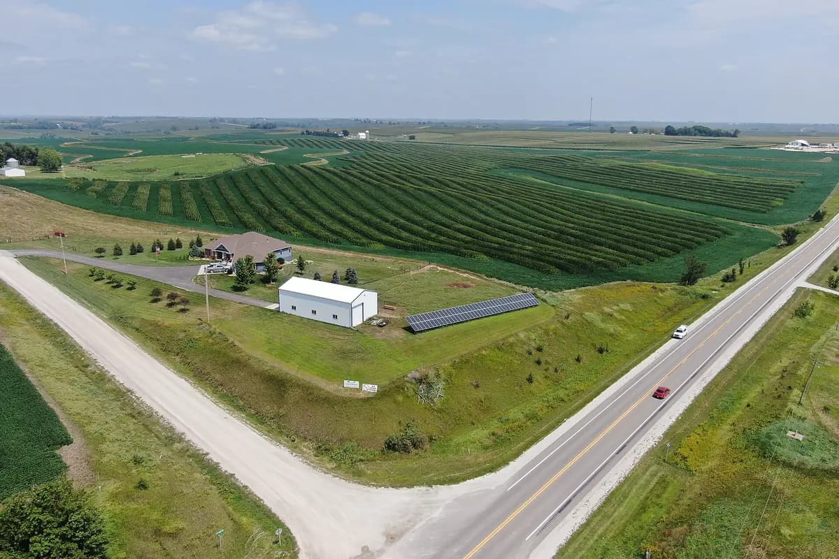 Aerial view of farmland with the crop field segmented and the barn, solar array and vehicles labeled