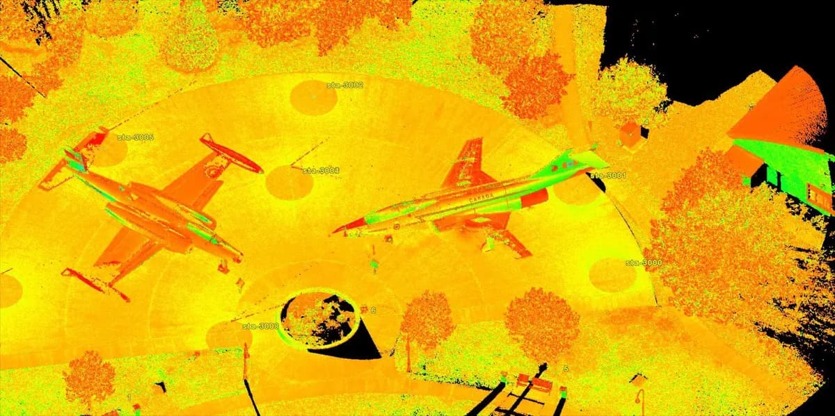 Aerial LiDAR point cloud of two parked aircraft with 3D cuboids and a vegetation segment