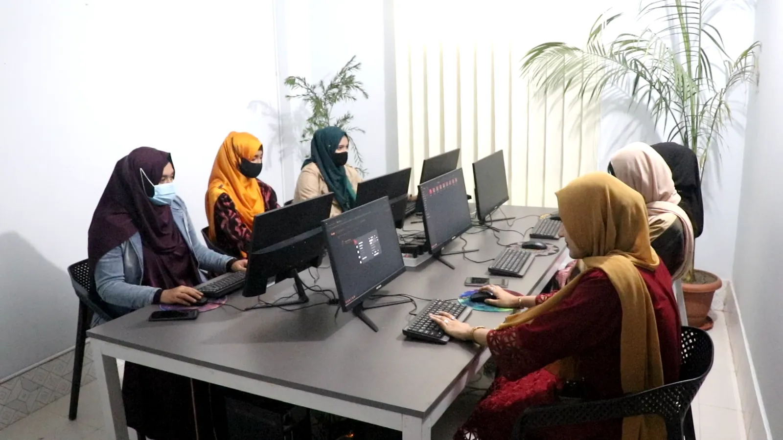 VettedHive annotators working at their computers in the Bhola office